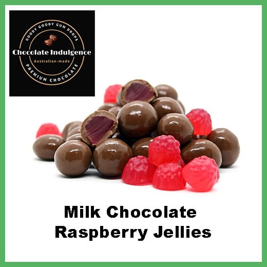 A pile of milk chocolate raspberry jellies and chocolate-covered raspberry pieces on a white background, with a black brand logo box reading 'Chocolate Indulgence' in the top left and the text 'Milk Chocolate Raspberry Jellies' at the bottom.