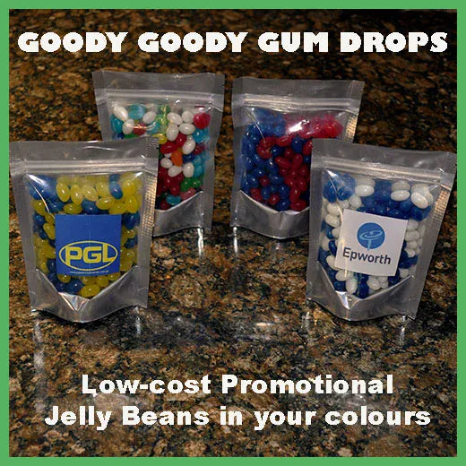Four bags of Goody Goody Gum Drops jelly beans on a granite surface with branding labels.